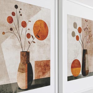 May include: Two framed abstract art prints with a minimalist style. Each print features a vase with stylized flowers and a geometric shape in shades of brown, orange, and white.