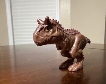 Juguete de la Cajita Feliz Cretácica del Campamento Jurásico Mundial de McDonald's 2020, dinosaurio Carnotaurus Toro