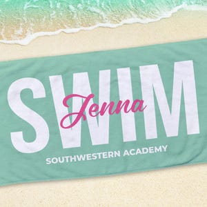 May include: A rectangular, light teal beach towel with the word "SWIM" in large white block letters. The name "Jenna" is in pink cursive script, and "SOUTHWESTERN ACADEMY" is printed below.