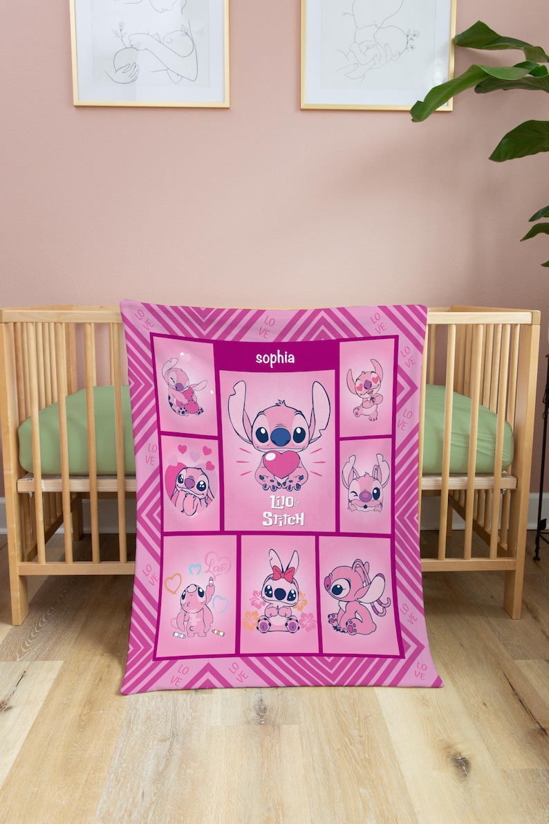 May include: Pink baby blanket featuring Stitch from Lilo & Stitch. The blanket has a grid design with various Stitch illustrations and the name "Sophia". The words "Lilo Stitch" are also visible.