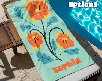 May include: A light teal beach towel with a floral design featuring orange and yellow flowers and teal leaves. The towel is personalized with the name "Sophia" in orange text. The text "6 Style Options" is in the upper right corner.