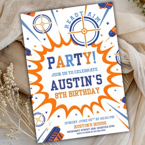 May include: White party invitation with blue and orange accents. The invitation reads "READY AIM PARTY!" and announces Austin's 8th birthday. Includes details for the event, such as the date, time, and location.