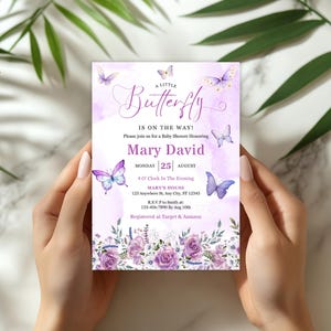 May include: A baby shower invitation with a watercolor design. The invitation features the text "A Little Butterfly is on the Way!" and includes the name "Mary David" and event details. The design includes purple butterflies and floral accents.
