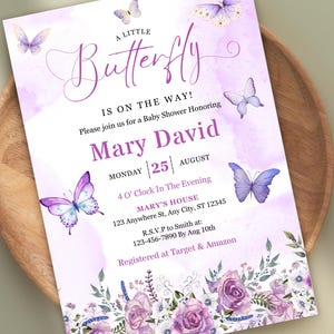 May include: A baby shower invitation with a watercolor design. The invitation features the text "A Little Butterfly Is On The Way!" in a script font, along with the names "Mary David" and event details. Purple butterflies and floral accents decorate the invitation.