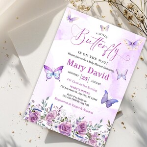 May include: A baby shower invitation with a watercolor design. The invitation features the text "A Little Butterfly Is On The Way!" and includes details for Mary David's baby shower, including the date, time, and location. The design incorporates purple butterflies and floral elements.