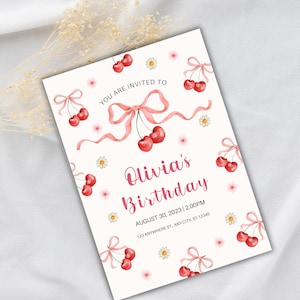 Puede incluir: Una invitaci&oacute;n de cumplea&ntilde;os con un dise&ntilde;o de acuarela. La invitaci&oacute;n presenta un fondo crema claro con ilustraciones de cerezas y margaritas. El texto dice "Olivia's Birthday" e incluye la fecha, la hora y la direcci&oacute;n.