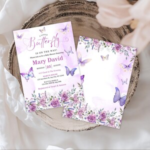 May include: Two baby shower invitations with a watercolor design. The invitations are lavender and white with butterfly and floral accents. The text reads "A Little Butterfly is on the Way!" and includes event details.
