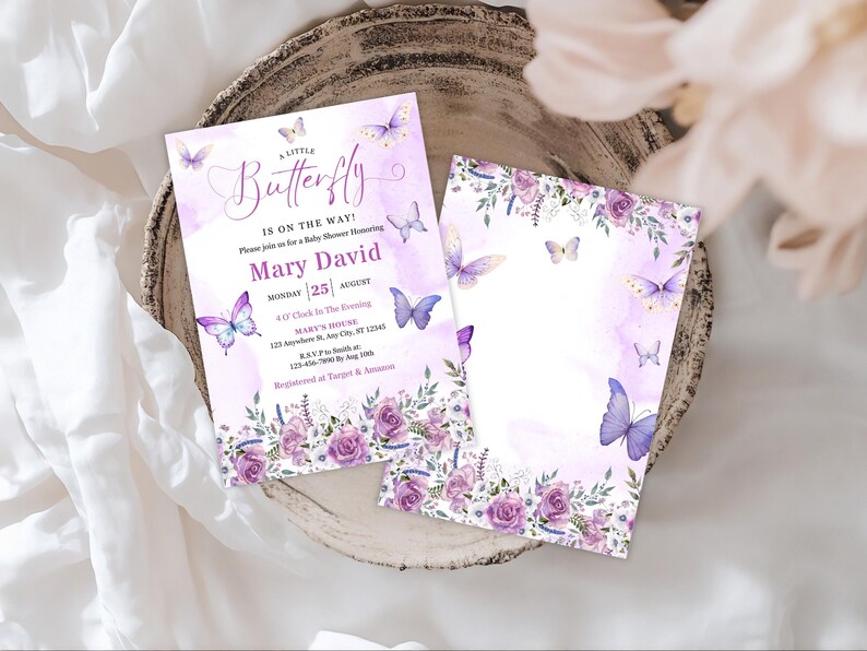 May include: Two baby shower invitations with a watercolor design. The invitations are lavender and white with butterfly and floral accents. The text reads "A Little Butterfly is on the Way!" and includes event details.