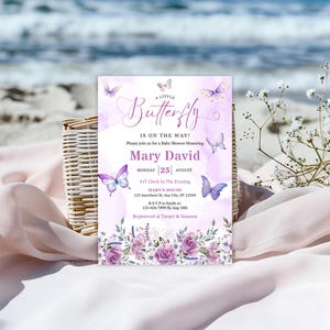May include: A baby shower invitation with a butterfly theme. The invitation features a watercolor background with butterflies and floral accents. The text reads "A Little Butterfly is on the Way!" and includes the name "Mary David".
