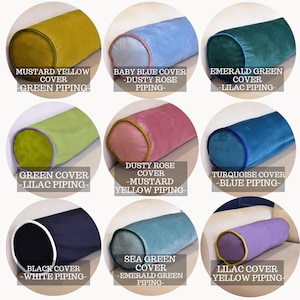 May include: Nine cylindrical throw pillows in various colors, including mustard yellow, baby blue, emerald green, green, dusty rose, turquoise, black, sea green, and lilac. Each pillow has contrasting piping and the text labels the color and piping.