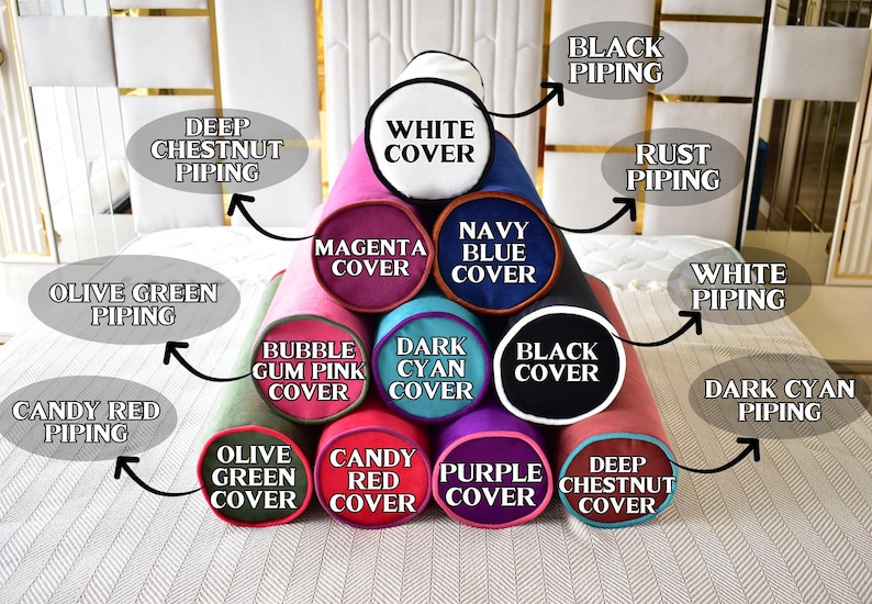 May include: A collection of cylindrical pillows in various colors, including magenta, navy blue, and black. Each pillow features a different colored cover and piping, with labels indicating the color names. The pillows are arranged in a pyramid shape.