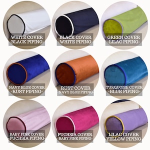 May include: Nine cylindrical bolster pillows in various colors, including white, black, green, navy blue, rust, turquoise, baby pink, fuchsia, and lilac. Each pillow has contrasting piping and the text: "WHITE COVER - BLACK PIPING-".