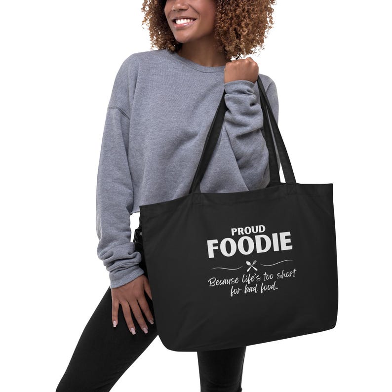 May include: Black tote bag with white text that reads "Proud Foodie Because life's too short for bad food."