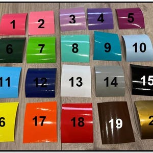 May include: Twenty colour swatches arranged in four rows of five. The swatches are numbered 1 through 20. The colours include pink, green, blue, white, grey, black, yellow, orange, red, and gold.