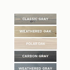 May include: Five wood samples stained in different colors: Classic Gray, Weathered Oak, Polar Oak, Carbon Gray, and Weathered Gray.