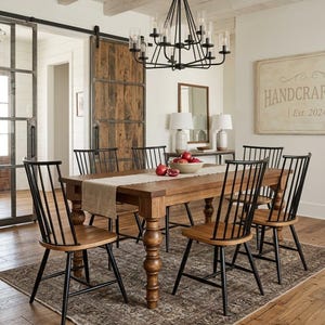 May include: A dining room set with a wooden table and six chairs. The chairs have black frames and wooden seats. A chandelier hangs above the table. A rug is under the table and chairs. The room has a rustic aesthetic.
