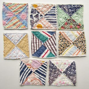 May include: Nine small, square quilted patches with a variety of colorful fabric patterns. Each patch is divided into four triangles, showcasing stripes, florals, and geometric designs in shades of blue, red, yellow, and green.