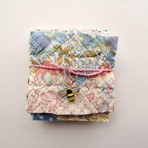 May include: A white ceramic mug with a black handle and the text "But First, Coffee" in a handwritten style. The mug is on a white surface. The mug is 4 inches tall.