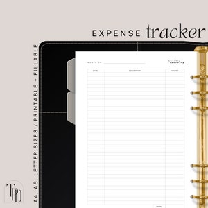 May include: A printable expense tracker with a black and gold binder. The tracker has columns for date, description, and amount. The text "MONTH OF" and "TOTAL" are visible.