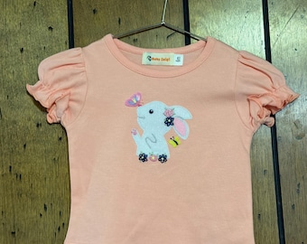 Maglietta da bambina con coniglietto floreale arancione