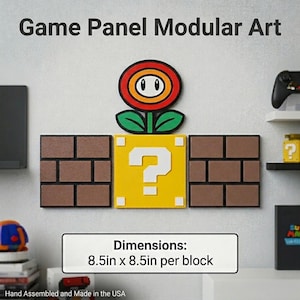 May include: Modular wall art with a Super Mario Bros. theme. The set includes a red and yellow flower, a yellow question mark block, and two brown brick blocks. Each block measures 21.6 cm by 21.6 cm. Hand assembled and made in the USA.