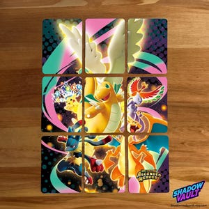 May include: Nine colorful trading cards featuring various Pokémon characters. The cards have a black background with vibrant pink, teal, and purple accents. The text "ASCENDED HEROES" is visible on one card, and the Shadow Vault logo is in the bottom right corner.
