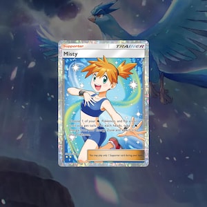 May include: A Pokemon trading card featuring Misty, a female character with orange hair, wearing a blue and white swimsuit. The card is a Trainer card and has the text "Misty" and "Choose 1 of your Pokemon, and flip a coin until you get tails. For each heads, take a Energy from your Energy Zone and attach it to that Pokemon."