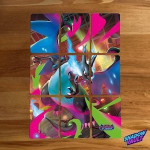 May include: Nine trading cards depicting a dragon-like creature with blue and black scales, fiery breath, and pink and green accents. The cards are arranged in a 3x3 grid on a wooden surface. The Shadow Vault logo is in the bottom right corner.