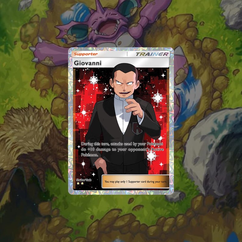 May include: A Pokemon trading card featuring Giovanni, a character from the Pokemon franchise. The card is a supporter card and has a red, black, and white color scheme. The card text reads: "During this turn, attacks used by your Pokemon do +10 damage to your opponent's Active Pokemon."