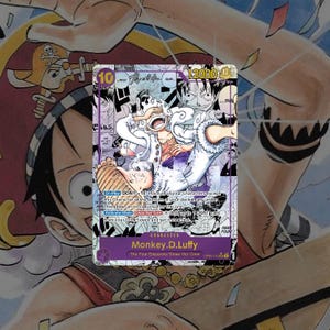 May include: A trading card featuring Monkey D. Luffy from the Four Emperors/Straw Hat Crew. The card has a purple and white design with the character in a dynamic pose. The card's details include a 10 and 12000 value, and text describing the character's abilities.