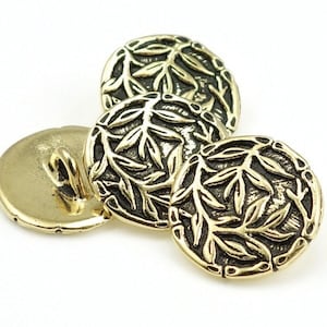 May include: Three gold-toned buttons with a leaf design. The buttons are round and have a raised design of leaves.