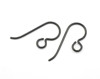 May include: Two black metal earring hooks. The hooks are made of a thin wire and have a small loop at the end.