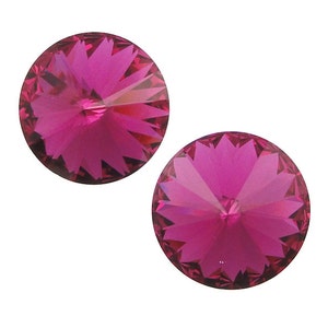 May include: Two pink crystal rhinestones with a starburst design.