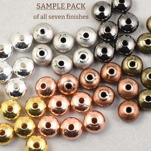 May include: A sample pack of seven metal bead finishes. The beads are round with a hole through the center. Finishes include silver, gunmetal, copper, bronze, and gold. The text "SAMPLE PACK of all seven finishes" is at the top.