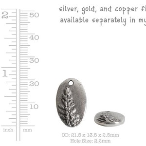 May include: Silver charm with a detailed design of a sprig of leaves. The charm is oval shaped and measures 21.5 mm x 13.5 mm x 2.5 mm with a 2.2 mm hole.