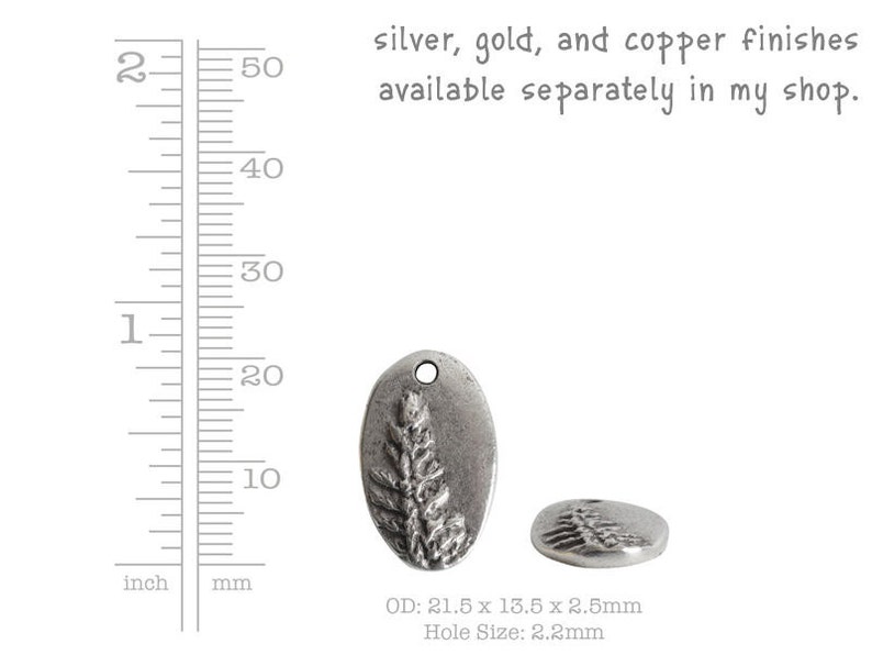 May include: Silver charm with a detailed design of a sprig of leaves. The charm is oval shaped and measures 21.5 mm x 13.5 mm x 2.5 mm with a 2.2 mm hole.