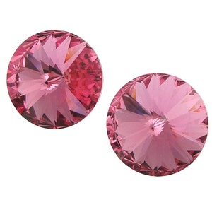 May include: Two pink crystal rhinestones with a faceted design.