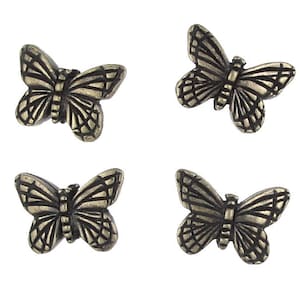 May include: Four antique gold-toned metal butterfly embellishments. Each butterfly has a detailed design with intricate wings.