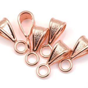 May include: Five rose gold pendant bails with a textured finish. Each bail has a loop on either end for attaching a chain and a pendant.