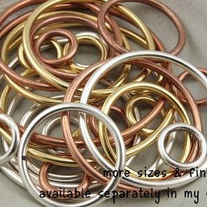 May include: A collection of silver, gold, and copper wire rings of varying sizes.  More sizes and finishes are available separately in the shop.