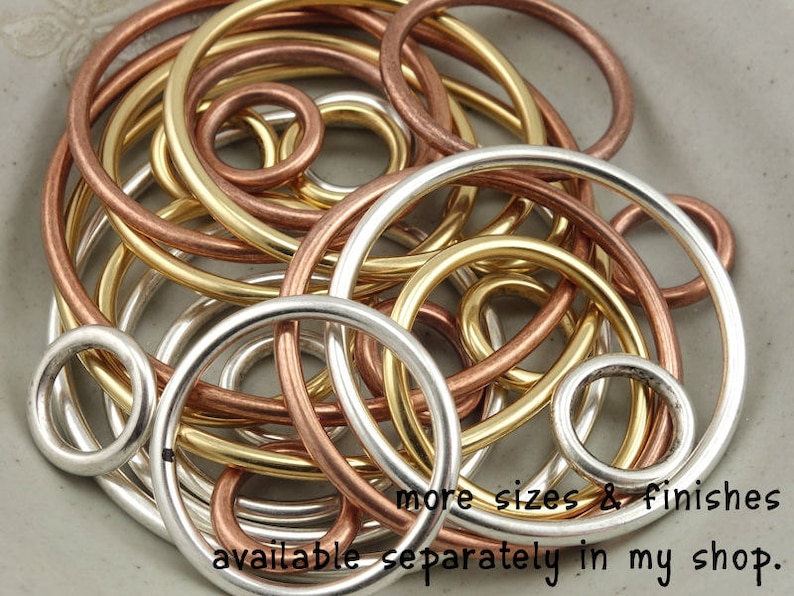 May include: A collection of silver, gold, and copper wire rings of varying sizes.  More sizes and finishes are available separately in the shop.