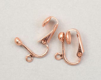 May include: Two rose gold clip-on earring findings. Each has a curved lever, a small ball, and a loop for attaching a charm. These findings are designed for non-pierced ears.