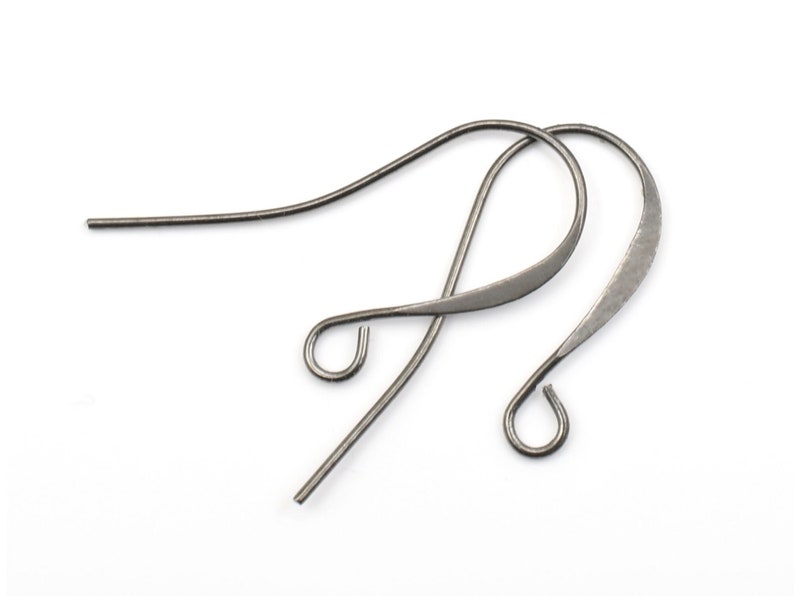 May include: A pair of silver-toned ear wires with a simple, curved design. The ear wires are made of metal and have a smooth finish.