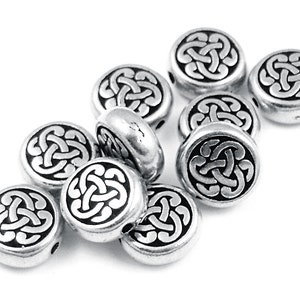 May include: Silver round beads with a black Celtic knot design.