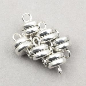 May include: Silver magnetic clasp for jewelry making. The clasp is made of multiple interlocking rings, creating a unique and stylish design.