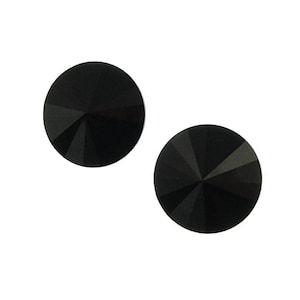 May include: Two black round rhinestones with a faceted design.
