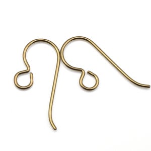 May include: Two gold-toned earring hooks, each with a small loop at the top and a longer, curved wire extending from the loop.