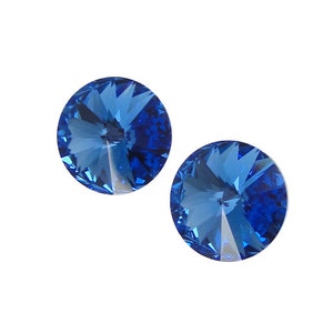 May include: Two round, faceted, blue crystal rhinestones.