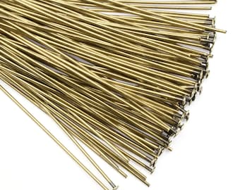 May include: A bundle of gold-colored metal head pins. The pins are thin and straight with a small, flat head at one end.