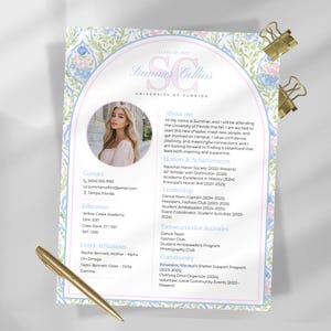 May include: A resume with a photo of a young woman, gold pen, and two gold paper clips. The resume includes contact information, education, Greek affiliations, and extracurricular activities. The document has a floral design.
